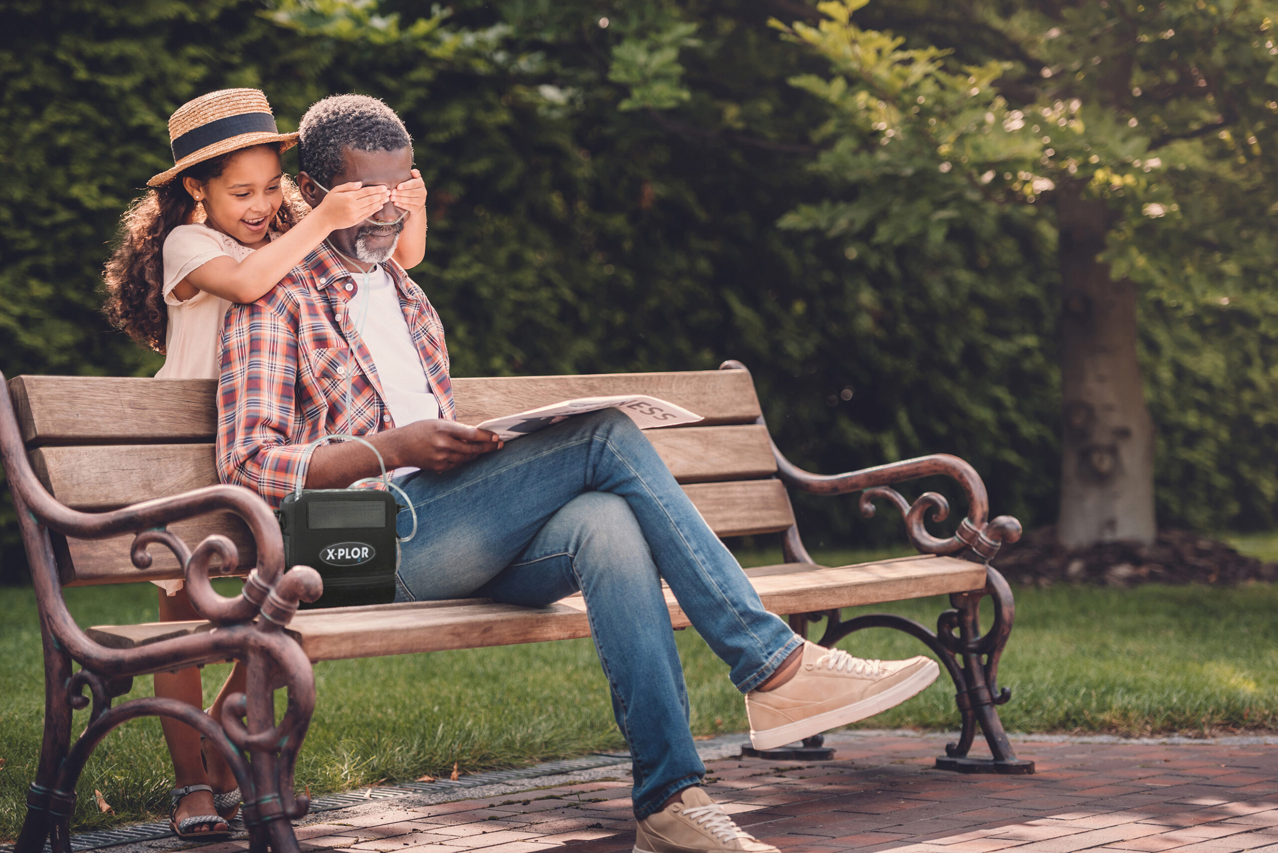 X-PLOR_Grandfather_Grandchild_Bench-web Grandfather and kid playing on park bench.